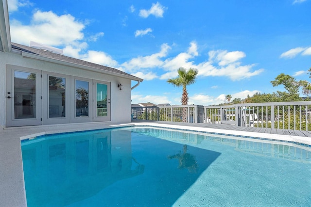 view of pool featuring french doors and a fenced in pool