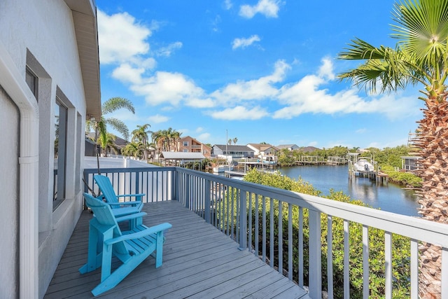 wooden deck featuring a water view and a residential view