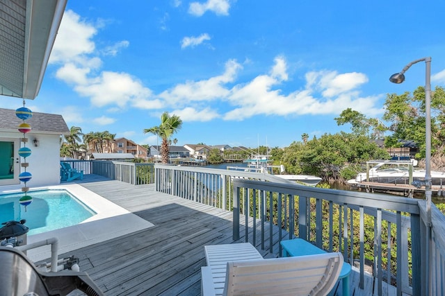 wooden terrace featuring a residential view and a fenced in pool