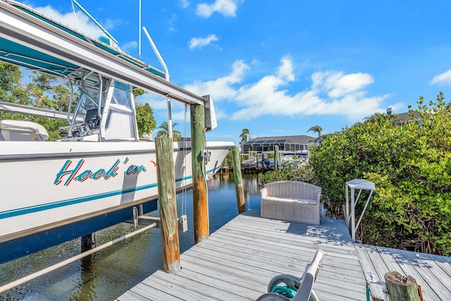 view of dock featuring a water view and boat lift