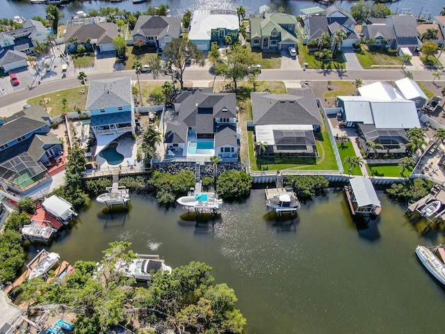 drone / aerial view featuring a water view and a residential view