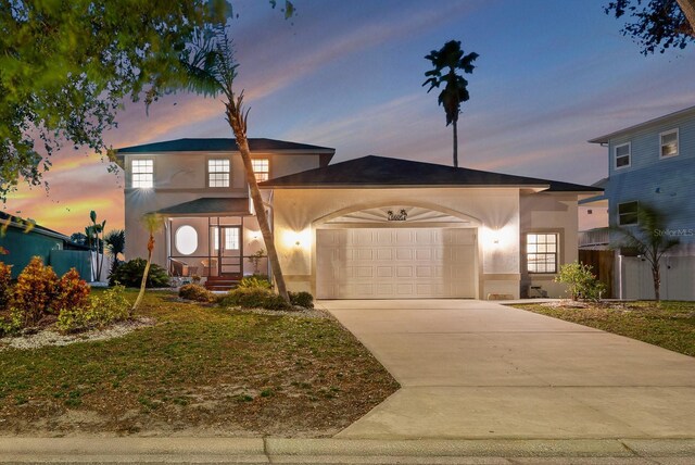 6606 Dolphin Cove Dr, Apollo Beach, FL 33572 - view of front of home with a garage, concrete driveway, and stucco siding