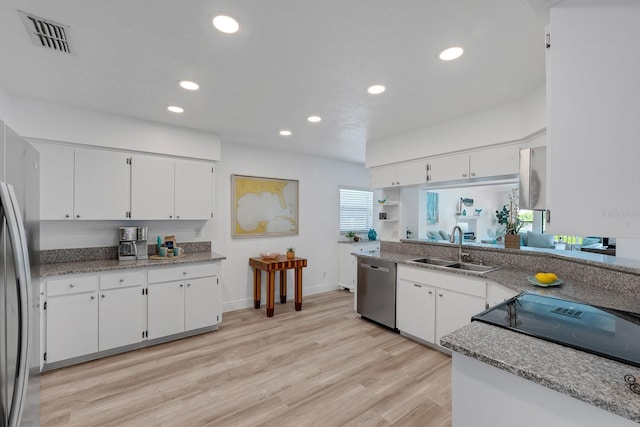 6606 Dolphin Cove Dr, Apollo Beach, FL 33572 - kitchen featuring a sink, stainless steel appliances, recessed lighting, and white cabinetry