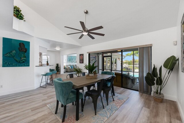 6606 Dolphin Cove Dr, Apollo Beach, FL 33572 - dining area featuring baseboards, light wood-style flooring, ceiling fan, and high vaulted ceiling