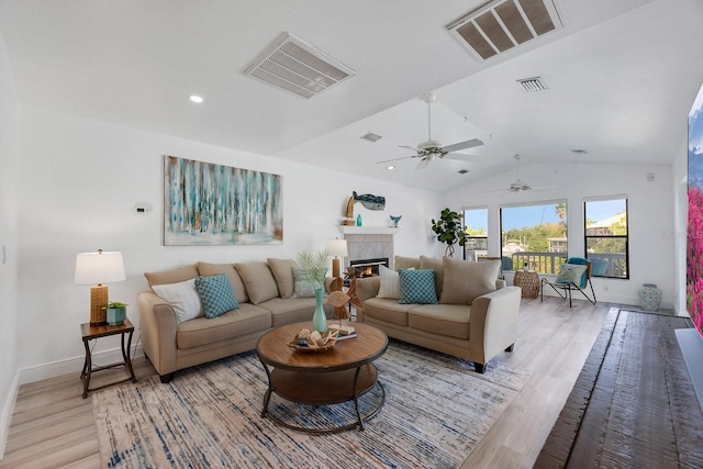 6606 Dolphin Cove Dr, Apollo Beach, FL 33572 - living area featuring light wood-type flooring, baseboards, lofted ceiling, a fireplace, and a ceiling fan