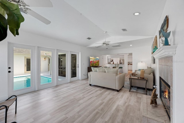 6606 Dolphin Cove Dr, Apollo Beach, FL 33572 - living room featuring ceiling fan, lofted ceiling, a fireplace, light wood-style floors, and recessed lighting