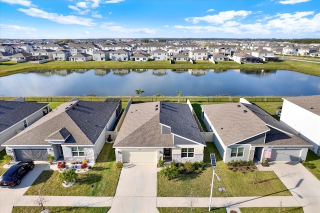 birds eye view of property with a residential view and a water view