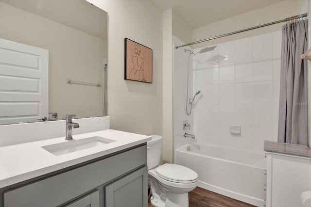 full bath featuring vanity, toilet, wood finished floors, and shower / bath combo