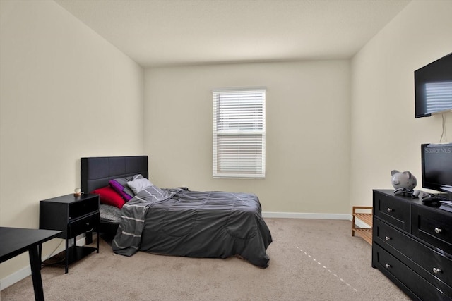 bedroom featuring carpet and baseboards