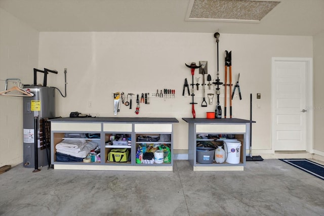 garage featuring a workshop area and electric water heater