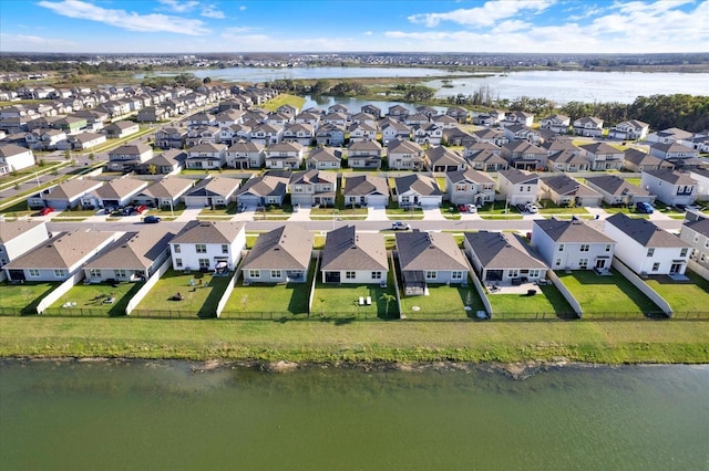 drone / aerial view with a residential view and a water view