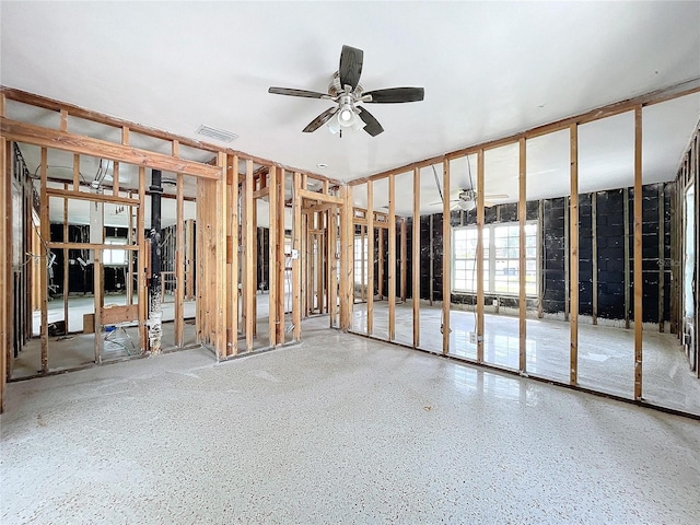 miscellaneous room with ceiling fan, visible vents, and speckled floor