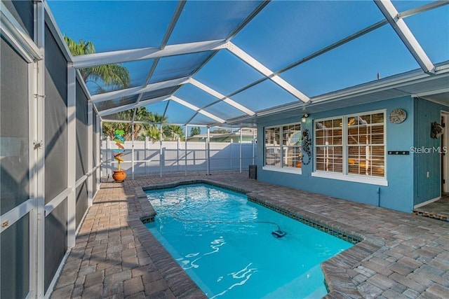 view of swimming pool featuring a fenced in pool, a lanai, a patio, and fence