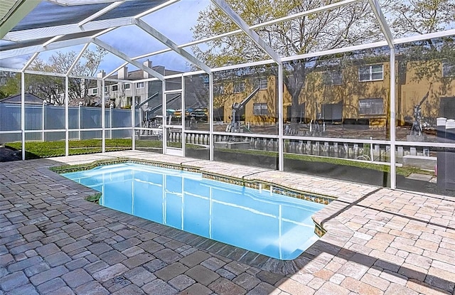 view of swimming pool featuring a patio, a residential view, a lanai, and a fenced in pool