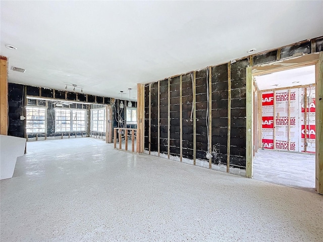 interior space featuring speckled floor and visible vents