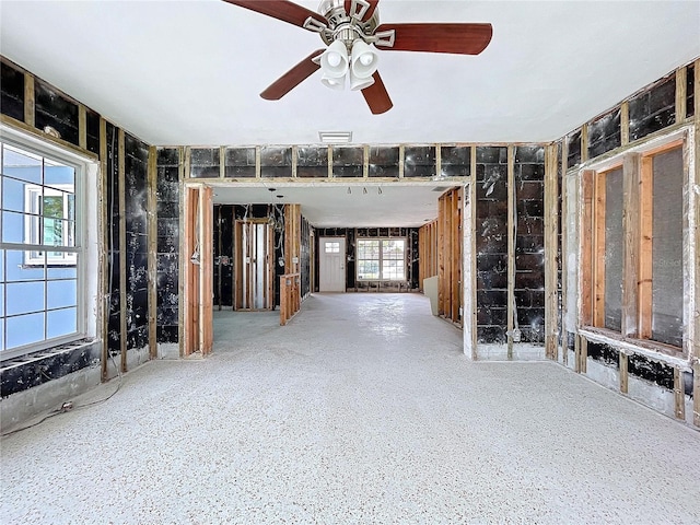 unfurnished living room featuring ceiling fan