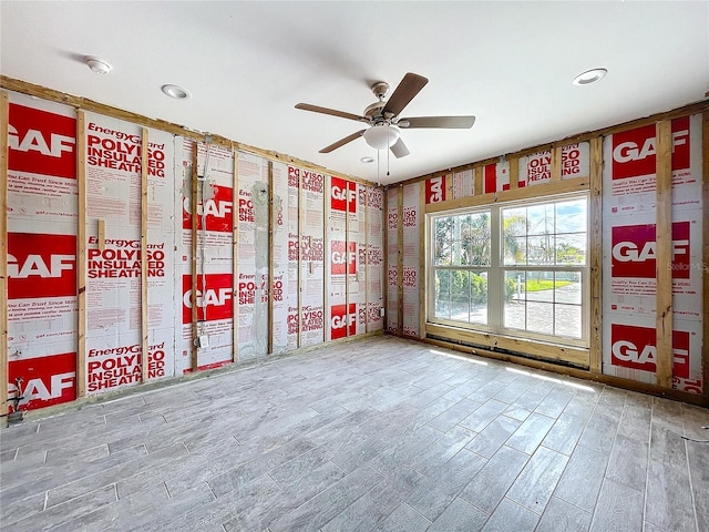 empty room featuring a ceiling fan and wood finished floors