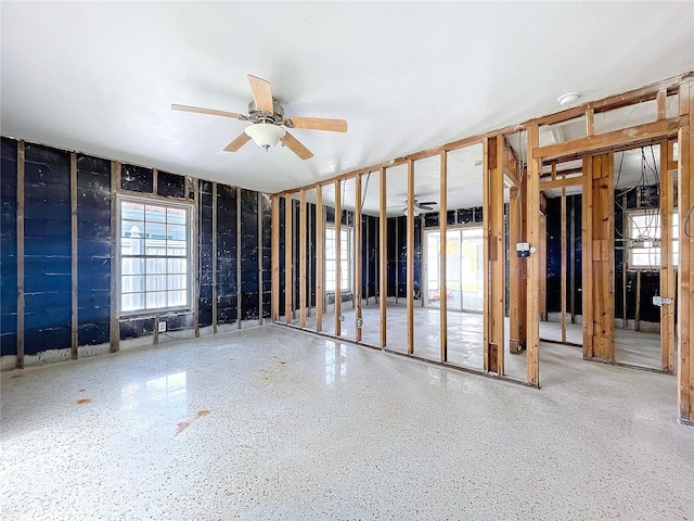 miscellaneous room featuring a ceiling fan and speckled floor