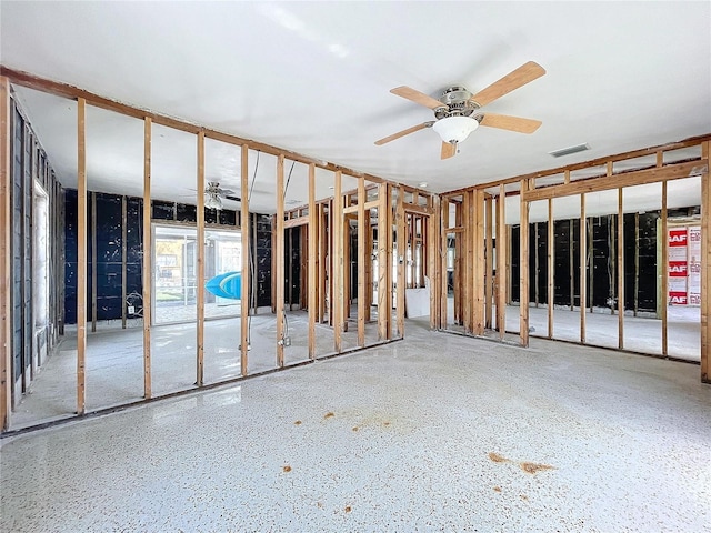 miscellaneous room with speckled floor, visible vents, and a ceiling fan