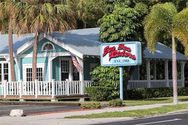 exterior space featuring covered porch and metal roof