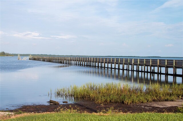 view of dock with a pier and a water view