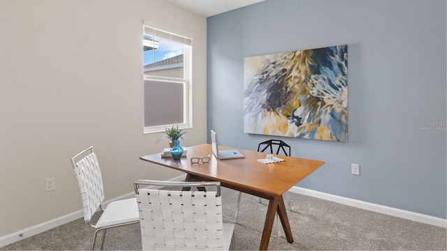 dining space with carpet and baseboards