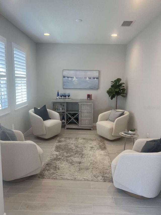 living area with visible vents, recessed lighting, baseboards, and wood tiled floor