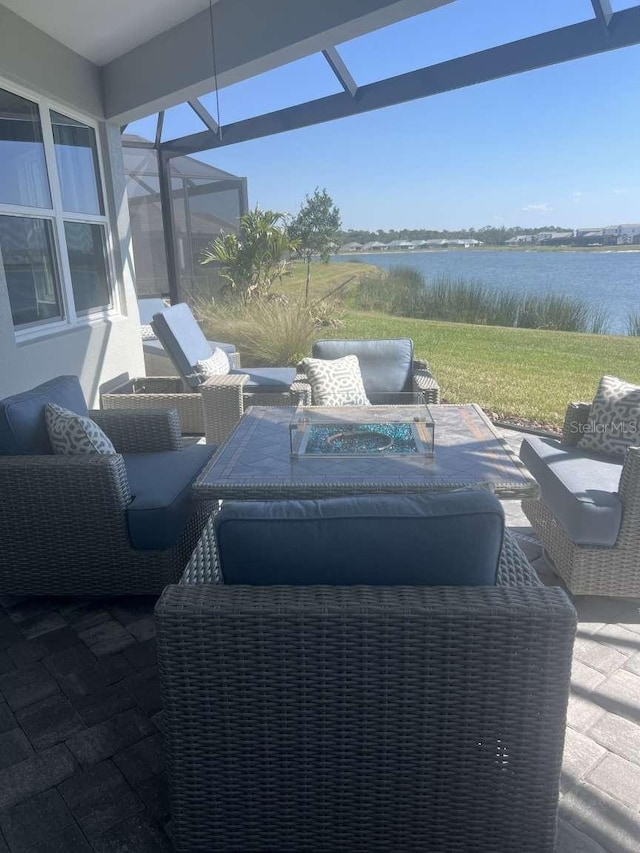 interior space featuring a lanai, outdoor lounge area, and a water view