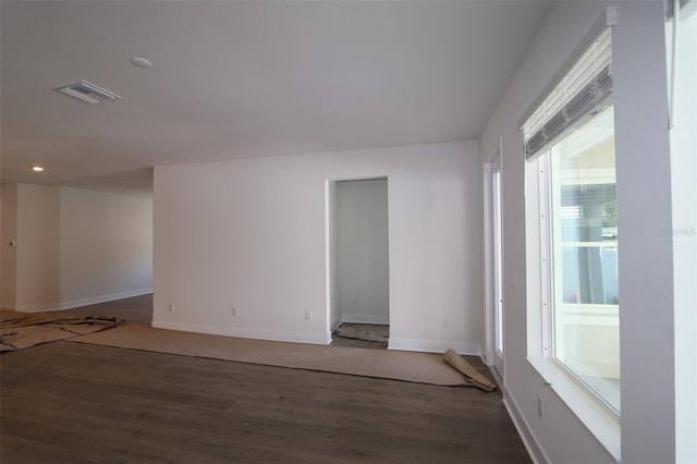 unfurnished room with recessed lighting, visible vents, baseboards, and wood finished floors