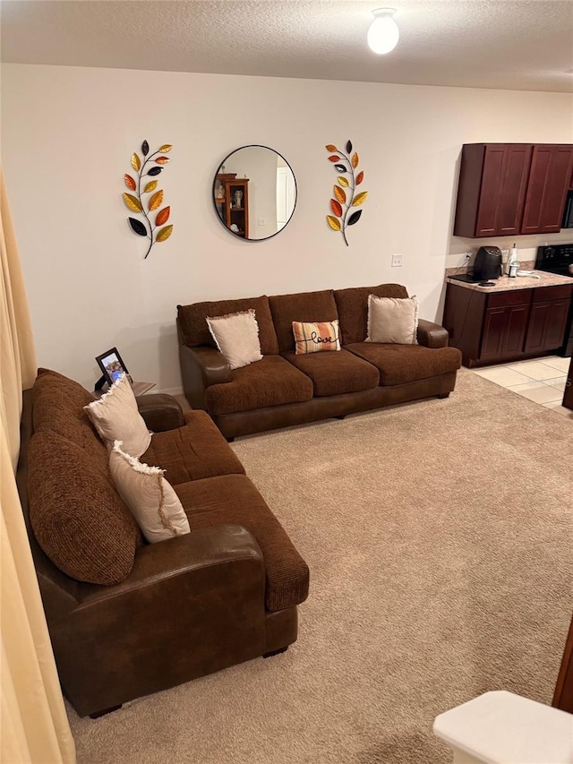 living area with light tile patterned floors and a textured ceiling