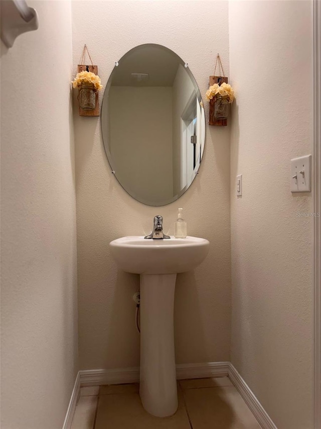 bathroom featuring baseboards and tile patterned flooring