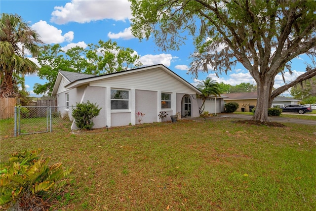 single story home with a front yard, fence, and stucco siding