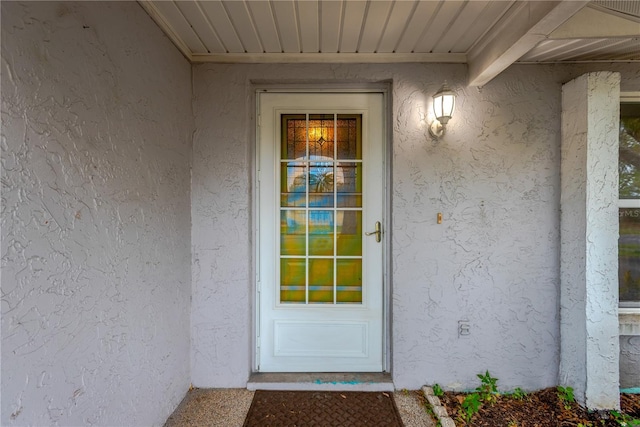 property entrance featuring stucco siding