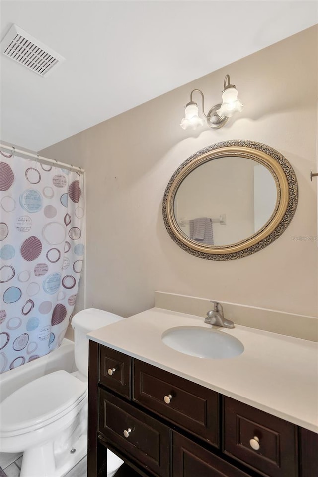 bathroom with vanity, shower / tub combo, toilet, and visible vents