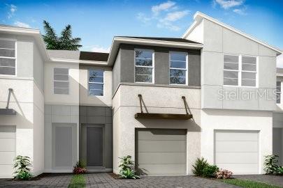 view of front of property with a garage, driveway, and stucco siding