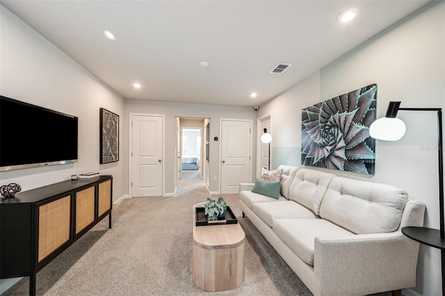 living room with carpet, visible vents, baseboards, and recessed lighting