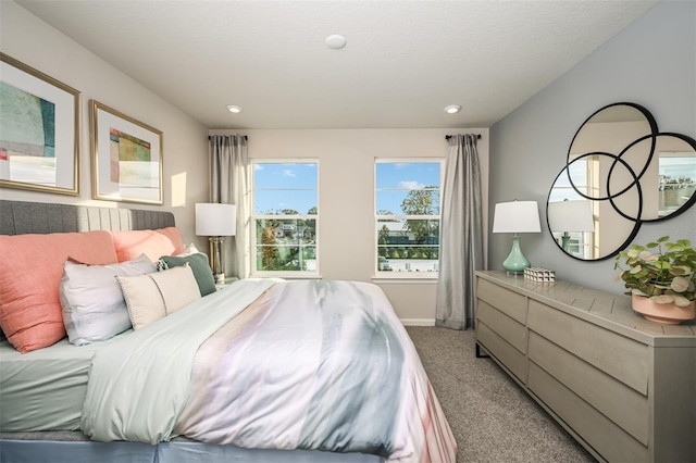 bedroom featuring recessed lighting, light colored carpet, and baseboards