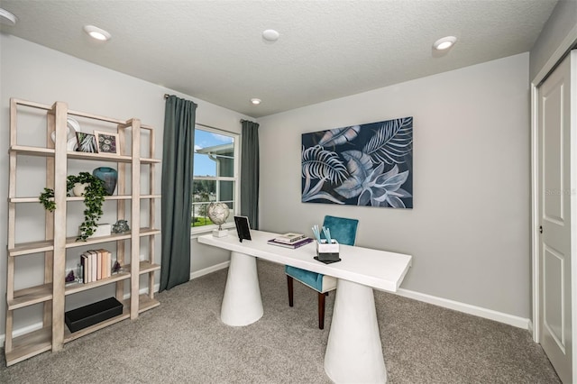 office space featuring carpet, a textured ceiling, and baseboards