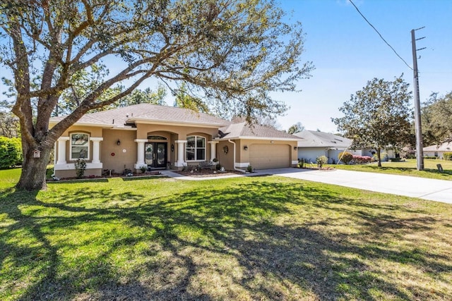 ranch-style house featuring driveway, a front yard, a garage, and stucco siding