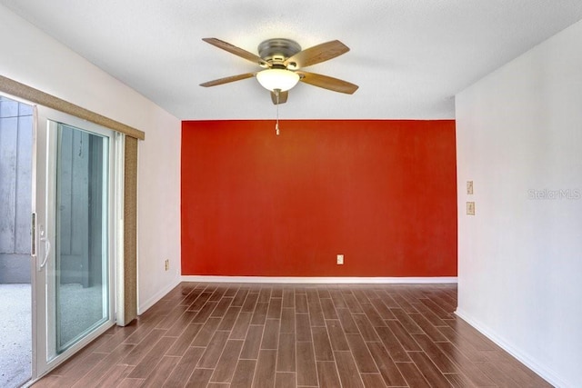 empty room featuring wood finish floors, a ceiling fan, and baseboards