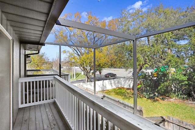 wooden deck featuring glass enclosure