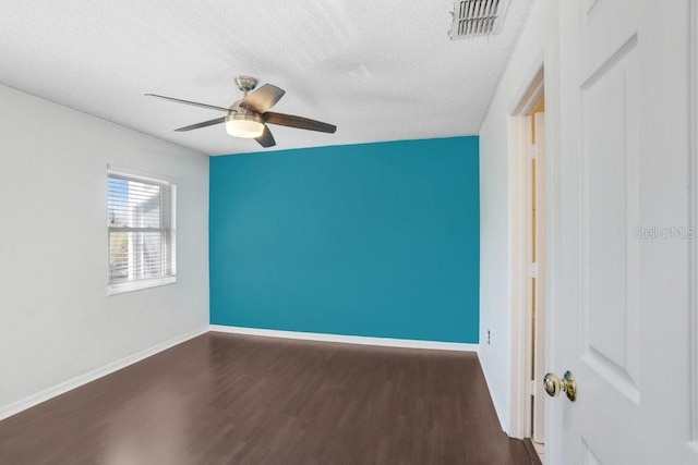 unfurnished room featuring a ceiling fan, a textured ceiling, baseboards, and wood finished floors