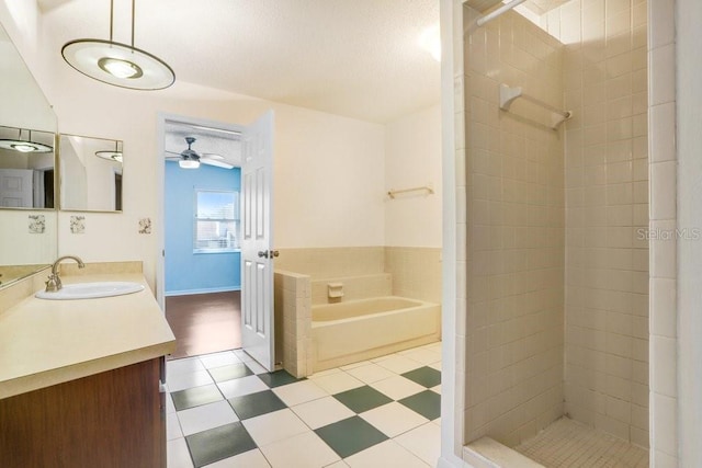 full bath featuring vanity, a tile shower, a bath, and a ceiling fan