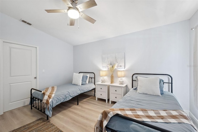 bedroom featuring visible vents, light wood-type flooring, and a ceiling fan