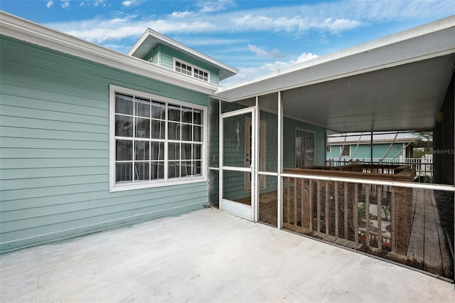 view of patio / terrace featuring a sunroom