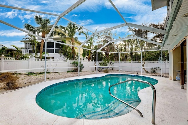 view of pool featuring a fenced in pool, glass enclosure, and a fenced backyard