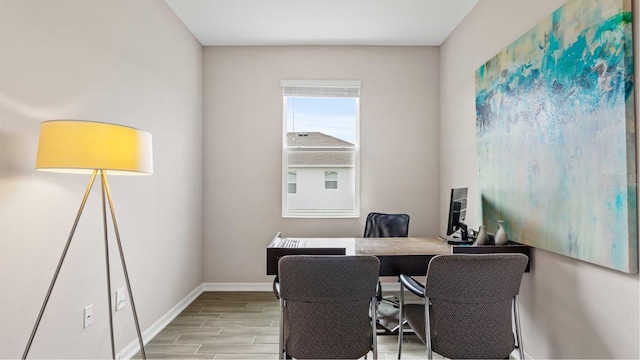 office with baseboards and wood tiled floor