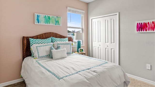 carpeted bedroom featuring a closet and baseboards