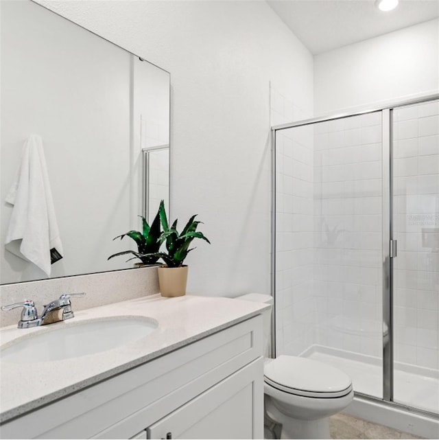 bathroom featuring toilet, a shower stall, recessed lighting, and vanity