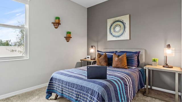 bedroom featuring carpet and baseboards